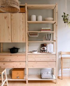 a kitchen with wooden cabinets and shelves filled with dishes