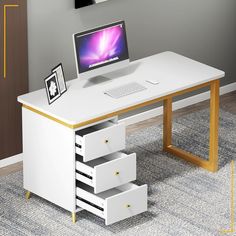 a white desk with drawers and a computer on it