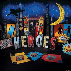 there is a man and woman standing in front of the word hero's surrounded by comic books