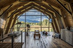 the inside of a wooden building with lots of windows and wood flooring on it