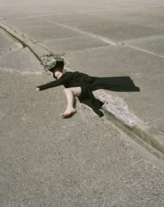 a woman laying on the ground with her legs spread out