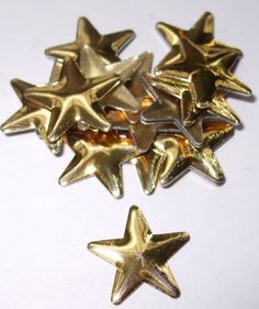 five shiny gold stars on a white surface