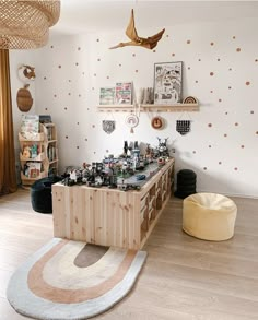 a living room filled with lots of furniture and decor on top of a hard wood floor