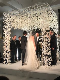 the bride and groom are getting married in front of their guests at this wedding ceremony