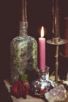 a candle and some rocks on a table