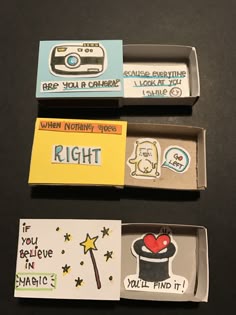 three different boxes with magnets and stickers on them, one has a camera