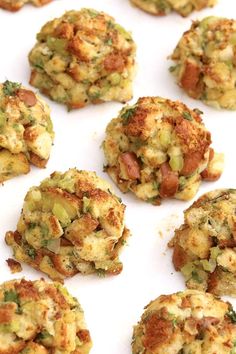 several crab cakes are arranged on a white surface