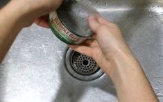 a person is washing their hands in the sink