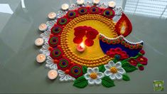 a decorated diya with lit candles and flowers