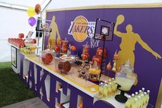 a basketball themed bar is set up with orange and purple decorations on the sidelines