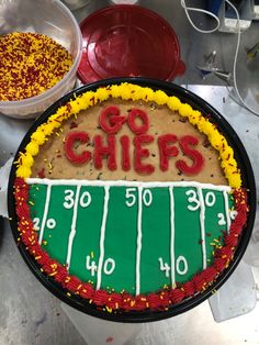 a football field cake with the word go chiefs on it and sprinkles