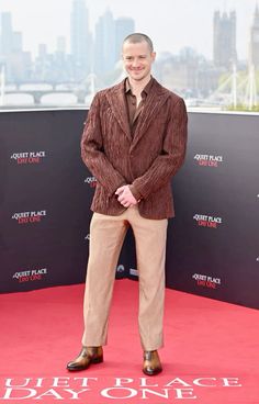 a man standing on top of a red carpet