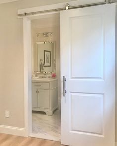 an open white door leading to a bathroom