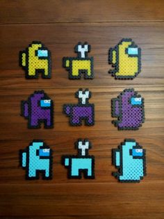 several pixel art pieces sitting on top of a wooden table