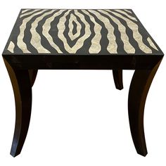 a zebra print coffee table sitting on top of a wooden frame with black and white stripes