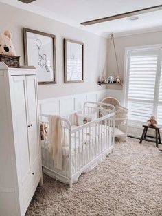 a baby's room with white furniture and pictures on the wall