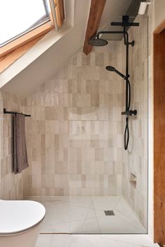 a bathroom with a skylight above it and a white bathtub in the corner