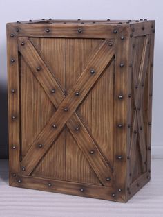 a wooden box with metal rivets on the sides and an opening at the top