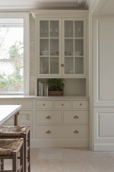 an empty kitchen with white cabinets and counter tops