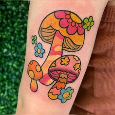 a colorful mushroom tattoo on the arm