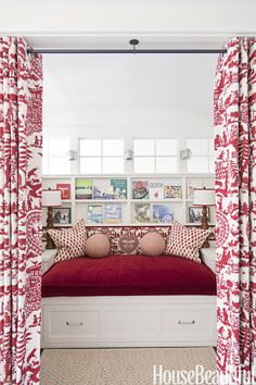 a red and white bed sitting under a window