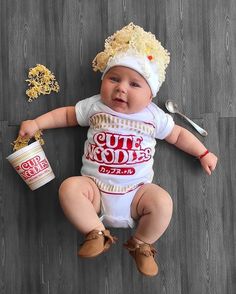 a baby is laying on the floor with some food