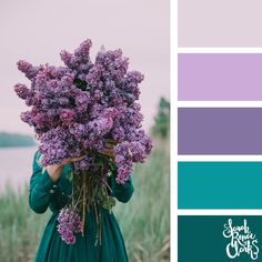 a woman in a green dress holding purple flowers