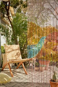 a wooden chair sitting on top of a patio next to a tree