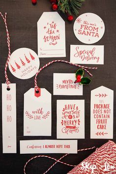 christmas gift tags are hanging on a table