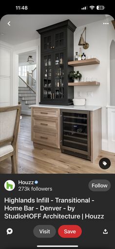 the app shows an image of a kitchen with black cabinets and wood flooring, along with