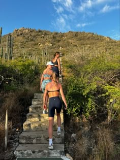 two women walking up some stairs in the desert