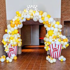 an entrance decorated with popcorn buckets and balloons