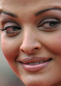 a close up photo of a woman's face smiling