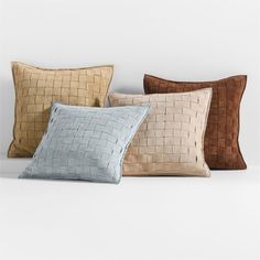 four different colored pillows sitting next to each other