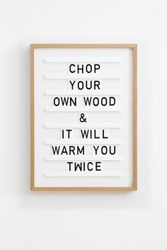 a framed sign that says, chop your own wood and it will warm you twice