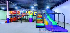 an indoor play area with slides and climbing equipment