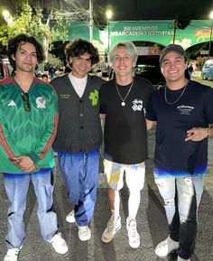 three men standing next to each other in the street