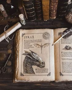 an open book sitting on top of a wooden table next to books and other items