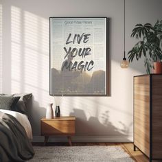 a poster on the wall above a bed in a room with a wooden dresser and side table