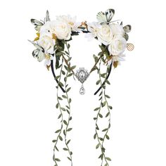 two white roses and leaves are attached to the back of a headpiece