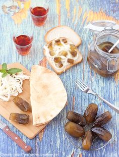 an assortment of food on a wooden table