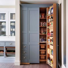 an open pantry door in the middle of a kitchen