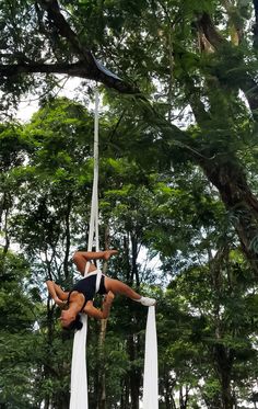 two people doing aerial acrobatics in the woods