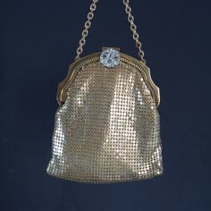 A ladies handbag woven from tiny gold coloured metal plates. Original 1920's USA. Fine example of a classic handmade icon for the 20's. Marked and made by the still well known Mesh Whiting & Davis Co USA. Strass jewelled and decorated clasp. Gold coloured satin inside. It has been around for over a 100 years but it is in fine shape. The inside has just a bit of colouring with age. Beautiful and surely wearable when you are invited to a Charleston party. Please have a look at all our vintage hand Classic Gold Coin Purse For Everyday Use, Retro Gold Bag As A Gift, Classic Gold Evening Bag As Gift, Classic Gold Evening Bag For Gift, Classic Gold Coin Purse As Gift, Classic Gold Clutch Evening Bag, Handmade Retro Evening Bag For Formal Events, Rectangular Gold Coin Purse For Evening, Gold Handmade Coin Purse For Everyday Use