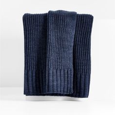 two dark blue knitted napkins sitting on top of each other