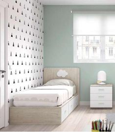 a bedroom with white furniture and wallpaper on the walls, along with a bed