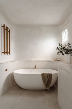 a white bath tub sitting inside of a bathroom