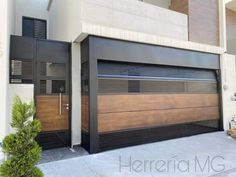 two garage doors are open in front of a house