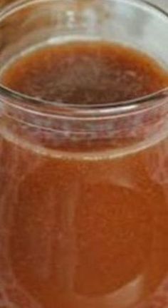 a glass jar filled with liquid sitting on top of a table