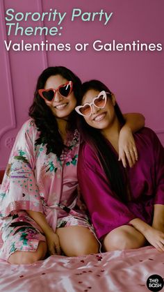 two women sitting on top of a bed wearing pink pajamas and matching heart shaped sunglasses